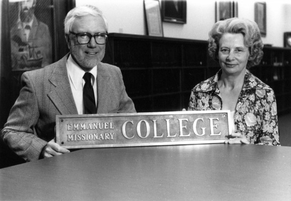 [Marley Soper and Louise Dederen standing with an old Emmanuel Missionary College sign in the Andrews University Heritage Room]