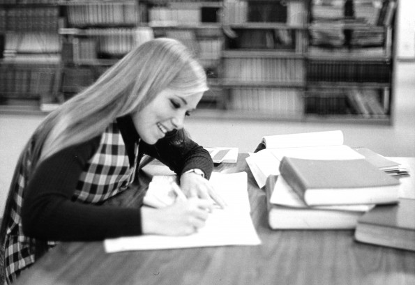 [Student studying at the reference stacks in James White Library at Andrews University]