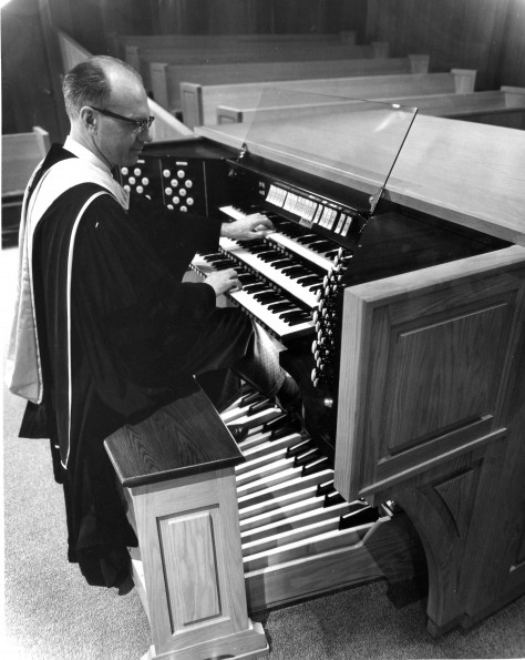 [C. Warren Becker plays the organ at a dedication service at Pioneer Memorial Church]