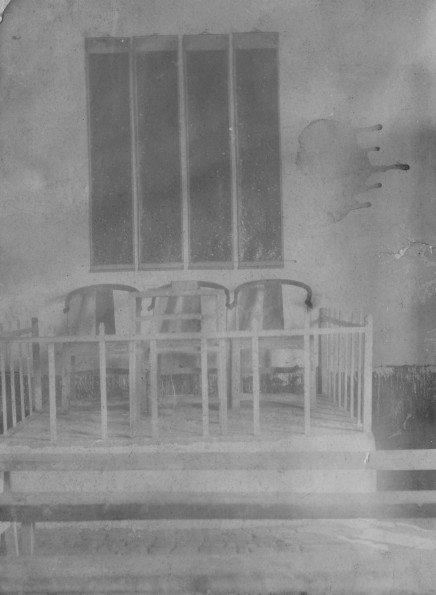 Three chairs in a platform possibly in a Chinese church