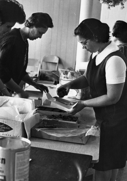 [Members from Pioneer Memorial Church packing Valentine's Day cookies for dormitory students]