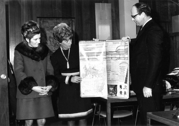 [Jacquelyn VanderLoon and June Tewksbury presenting a resume of 19th century world history to Joseph G. Smoot for the Andrews University Heritage Room]
