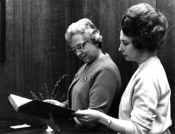 [Mary Jane Mitchell and Louise Dederen examine a rare book in the Andrews University Heritage Room]