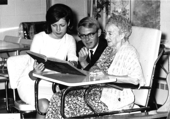 [Andrews University students read to an elderly resident of Carson's Convalescent Home]