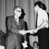 [Robert E. Firth, professor of business administration at Andrews University, presents the $150 Wilson & Verda Trickett schoalrship to junior business major Dick Hamstra.]