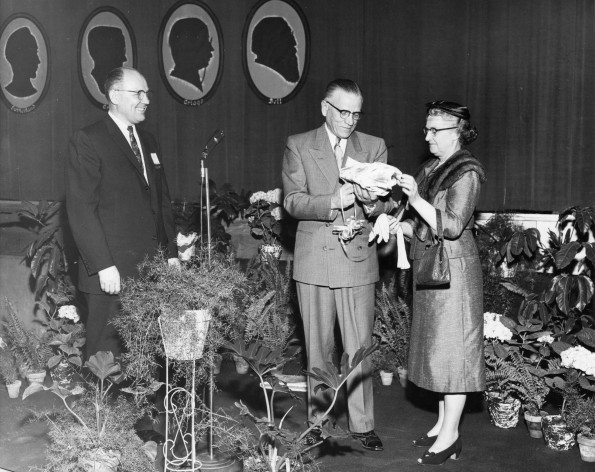 V. E. Garber watches the unwraping of a gift at Emmanuel Missionary College