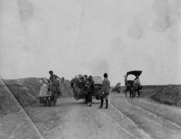 Chinese road with horse and people drawn carts