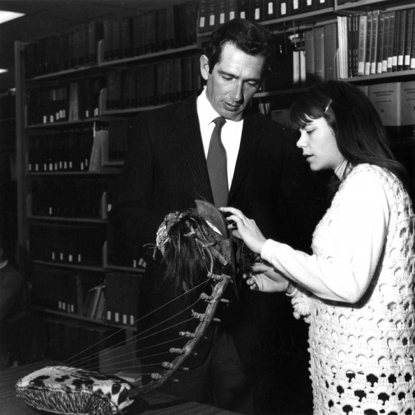 [Martin Ambs and Julie Shull examining a musical instrument from Congo that was recently donated to the James White Library]