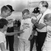 [Campus Little Leaguers at Andrews University try on new sports t-shirts]