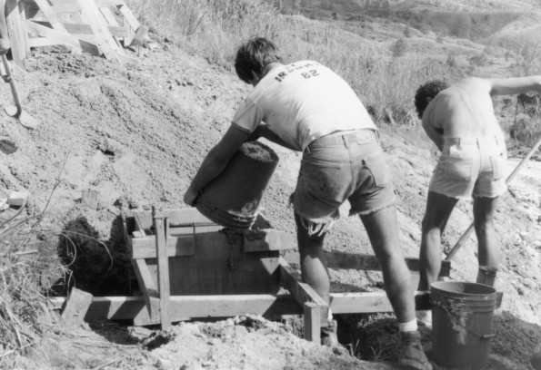 [Reinhold Grellmann and Keith Ratliff fill a radio tower winch pad with spilled concrete]