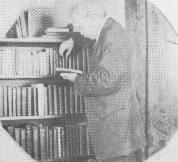 E. J. Waggoner with a portion of his library