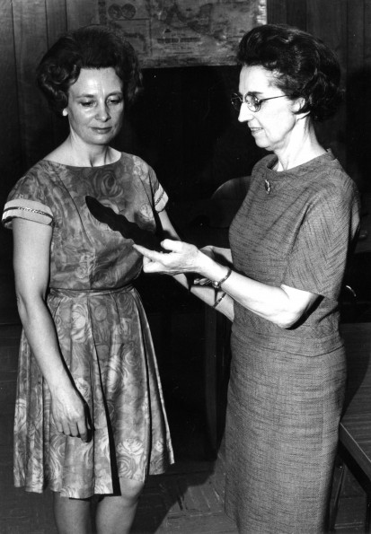 [Louise Dederen and Dena Hammill examine a dagger that once belonged to a Moro tribesman]