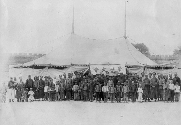 Evangelistic tent in Lanzhou, Gansu, China, with many people in front along with the western evangelist