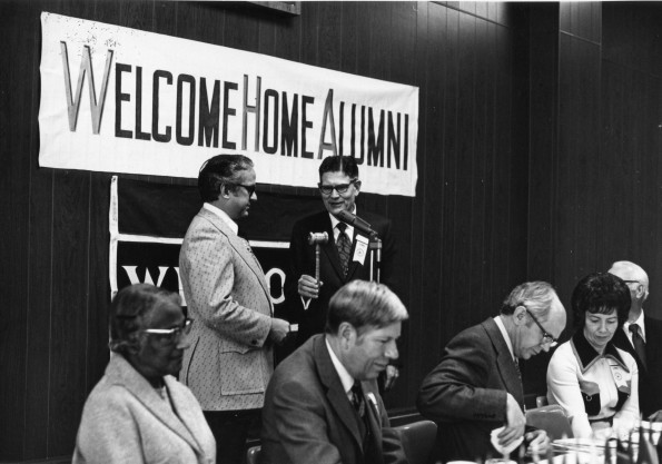[Wilson L. Trickett transferring the alumni association gavel to Floyd Costerisan]