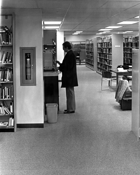 [Library patron in the stacks of James White Library at Andrews University]