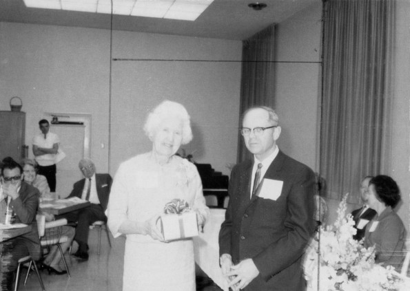 Arabellee Moore Williams, western alumnus of the year, receives a gift from Andrews University president, Richard Hammill