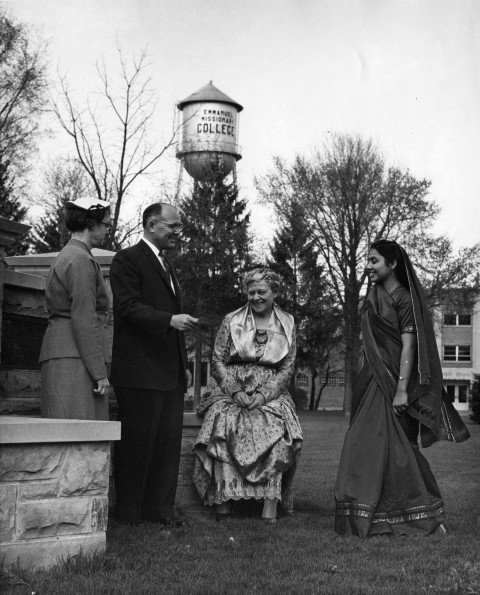 V. E. Garber chatting with alumni in international dress