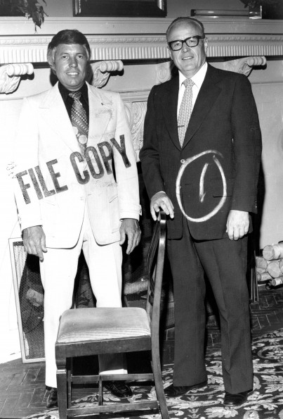 [Donald Prior and H. H. Hill with chair designed by John Harvey Kellogg]