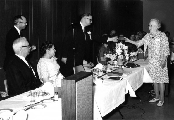 T. Rose Curtis, Emmanuel Missionary College class of 1926, receives a bronze plaque recognizing 50 years of service