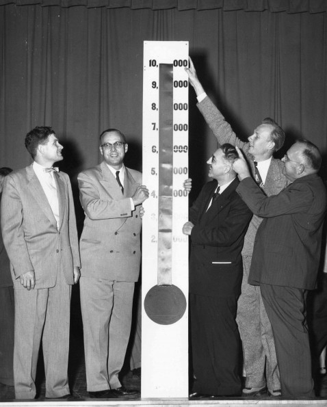 [Gentlemen standing with the 1953 ingathering goal meter]