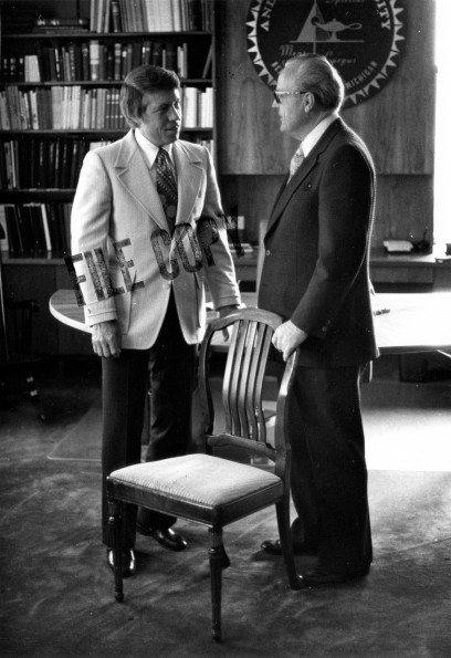 [Donald Prior and H. H. Hill with a chair designed by John Harvey Kellogg]