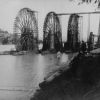 Four large water wheels under construction in a Chinese river