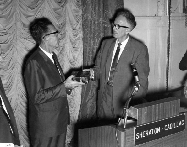 Ralph Waddell, the 1966 Andrews University Alumnus of the Year, receives a gift from Horace Shaw