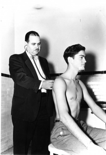 [Dr. Brown examines a patient at Emmanuel Missionary College clinic]