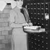 [Barbara H. Phipps standing by the card catalogue