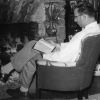 [Bernard Bowen reading by the fire place]