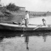 [Mary Kate Gafford and unknown friends boating on a lake]