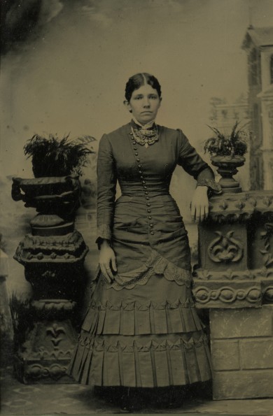 Unknown woman standing in a studio pose