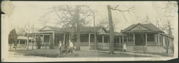 Front of the old Madison Sanitarium with two students working on the grounds and an unknown nurse