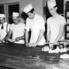 [Unknown men preparing food at Emmanuel Missionary College]