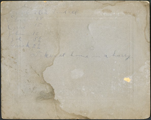 Back of photograph of Charles L. Kendall and family in front of their house in Arkansas