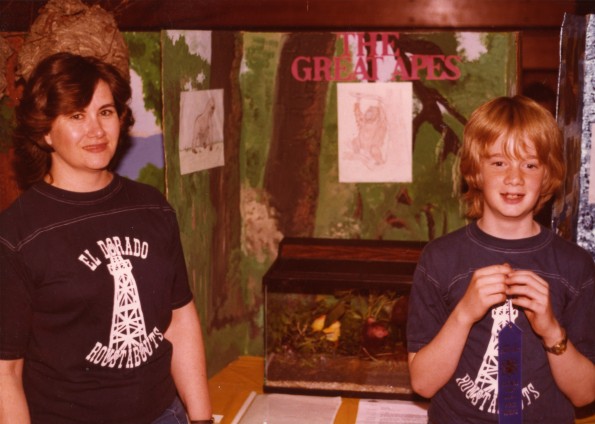 Jeff Swart and his mother and Linda Swart standing with his project on the great apes at the Pathfinder Education Fair in Bossier City, LA