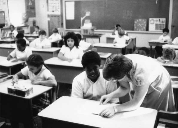 Linda Webb assisting a student at Jefferson Heights Junior Academy