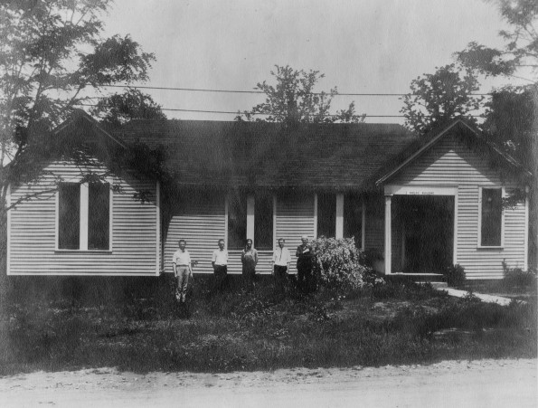 Five unknown young men standing in front of the Madison College Print Shop