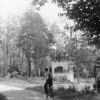 [Unknown boy riding his bike near John R. Peter's house in Pewee Valley, KY]