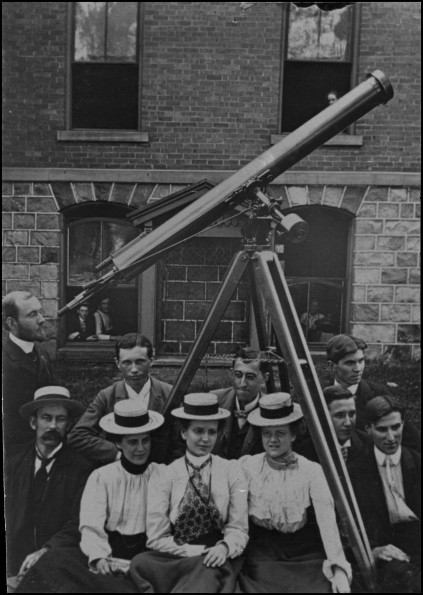 Battle Creek College astronomy class posing with large telescope