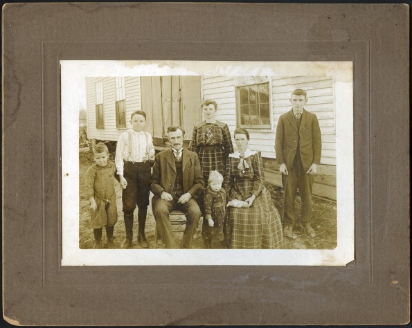 Charles L. Kendall and family in front of their house in Arkansas