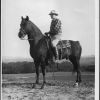 Leonard Brunie facing away from camera on horseback
