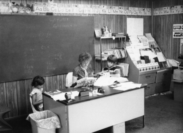 Roby Hightower assisting some students at the De Ridder Seventh-day Adventist School