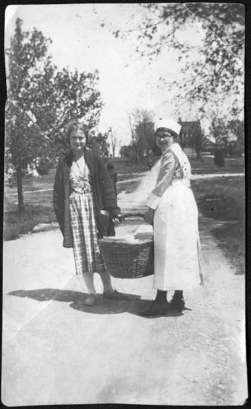 [Yolanda Sutherland with unknown Thelma holding a basket of linen at Madison College]