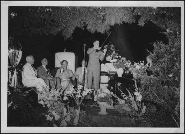 Sallie and E. A. Sutherland with others enjoy the entertainment at the Sutherland's 50th wedding anniversary celebration