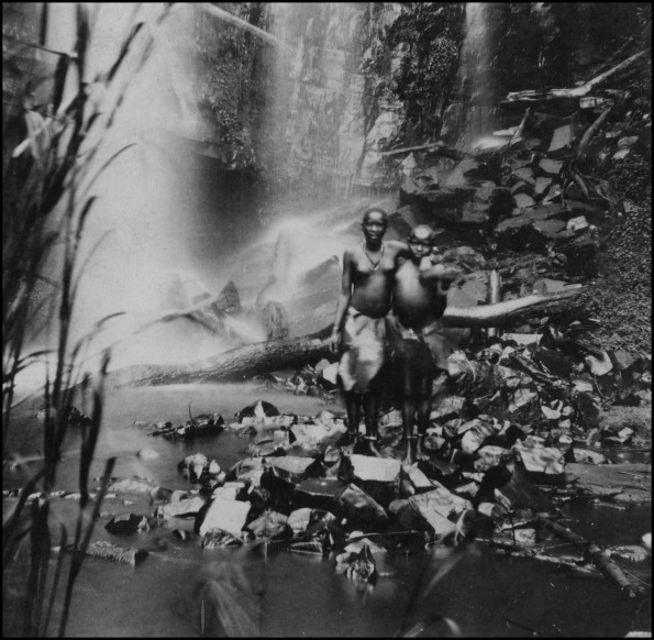Two Kisii women standing in front of Ekera Falls