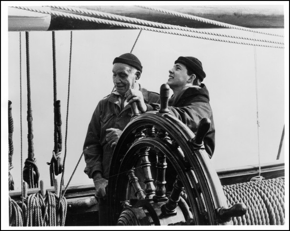 Parkin Christian and unknown young man steering the full scale model of the HMS Bounty