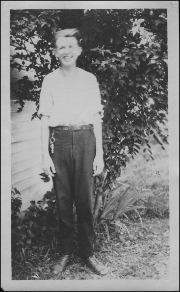 Joseph Edward Sutherland standing in front of a tree