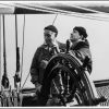 Parkin Christian and unknown young man steering the full scale model of the HMS Bounty