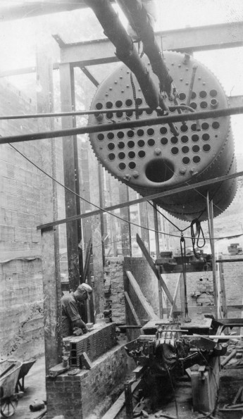 Installing central heat during the construction of an unknown building at Madison College